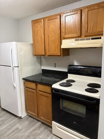 a kitchen with stainless steel appliances a stove a microwave and a sink