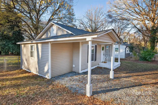 a view of a house with a yard covered in snow