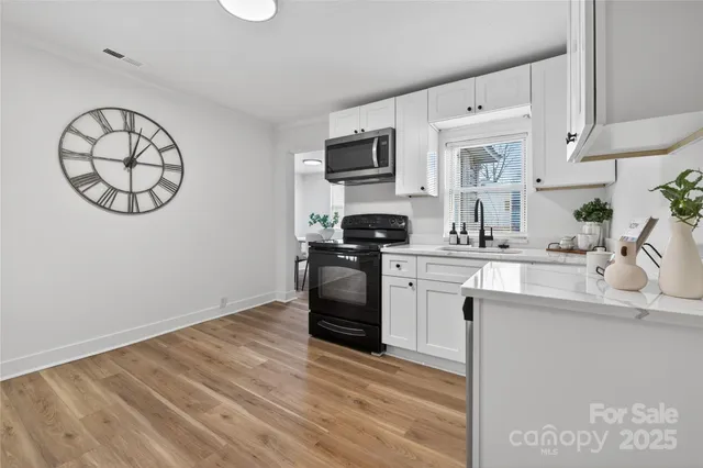a kitchen with a sink cabinets and stainless steel appliances