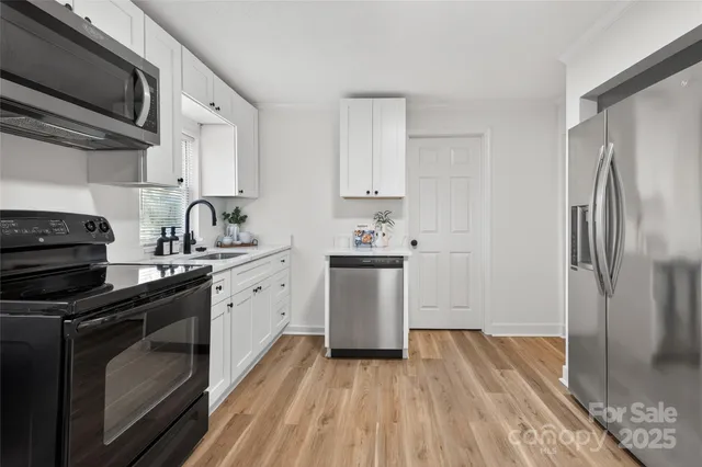 a kitchen with a sink stove and refrigerator