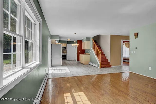 a view of entryway and hall with wooden floor