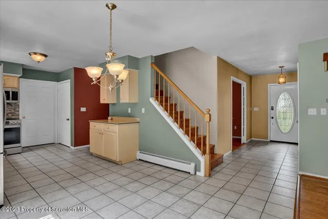 a view of a hallway with entryway and stairs