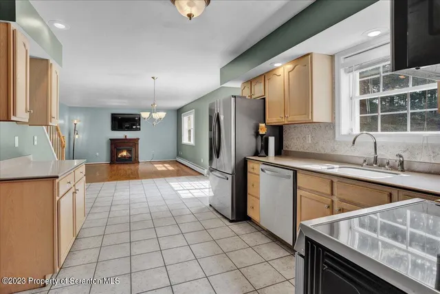 a kitchen with stainless steel appliances granite countertop a sink and cabinets