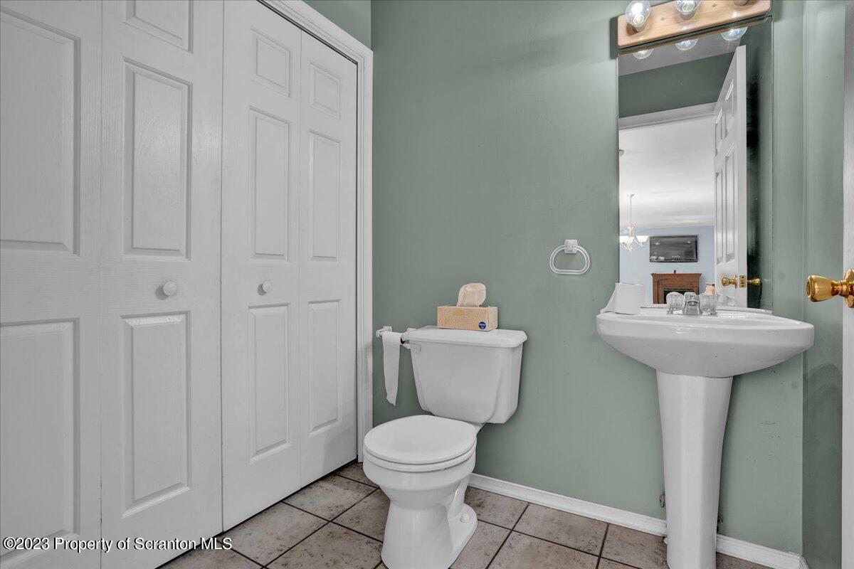 919 Old Logger Road Moscow, PA 18444 - Photo 16 of 36 a bathroom with a toilet sink and mirror