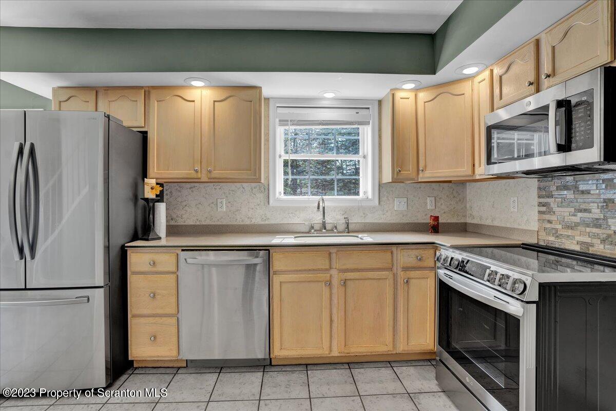 919 Old Logger Road Moscow, PA 18444 - Photo 2 of 36 a kitchen with cabinets appliances and a sink