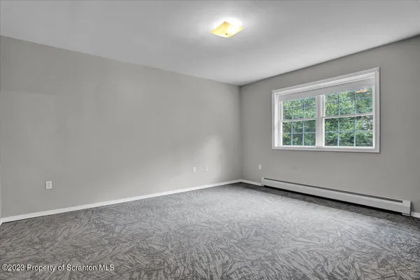 an empty room with a empty space and windows