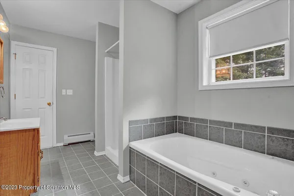 a bathroom with a bathtub and a shower