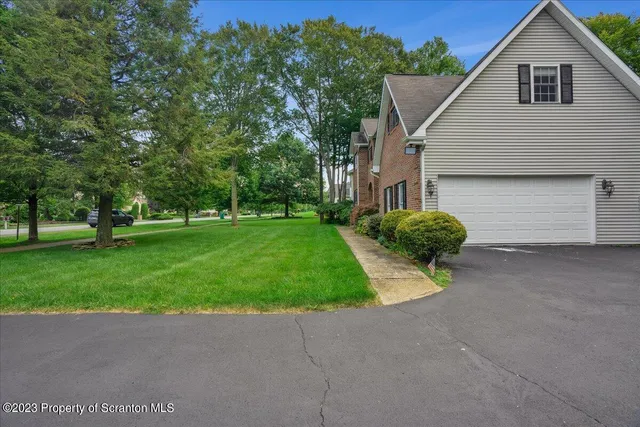 a view of a house with a yard and garage