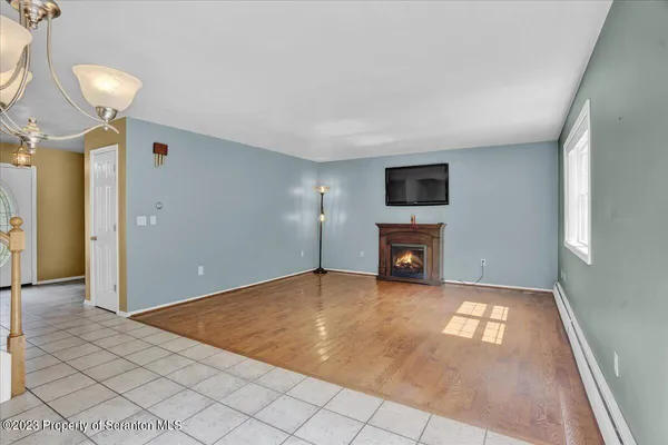 a view of a livingroom with a fireplace and window