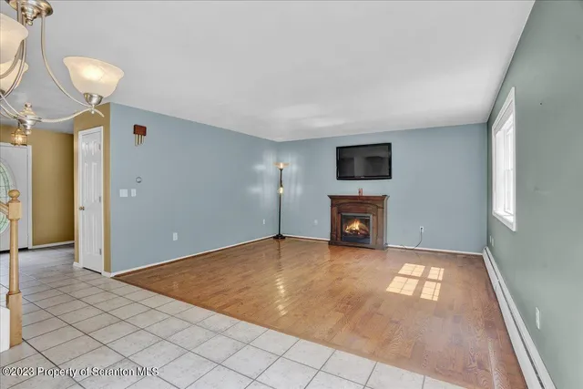 a view of a livingroom with a fireplace and window