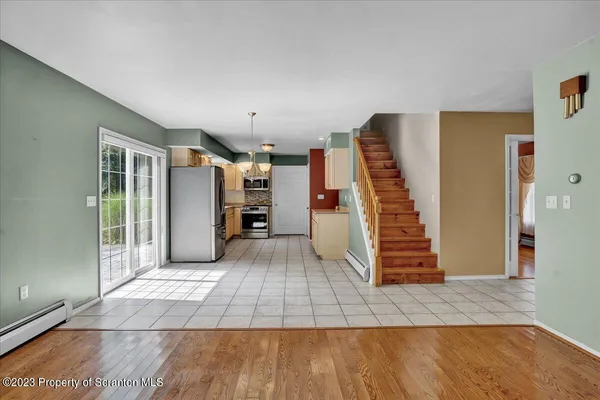 a view of entryway with wooden floor and stairs