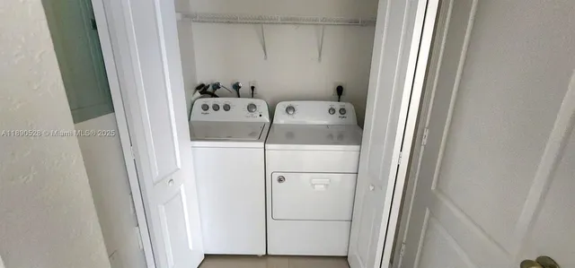 a front view of a house with a garden and trees