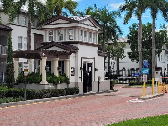 a front view of a house with a garden and plants