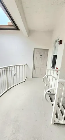 a view of an empty room with white walls