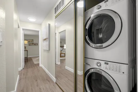 a view of a hallway with washer and dryer