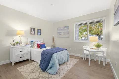 a bedroom with a bed and a window