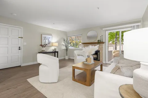 a living room with furniture a window and a fireplace