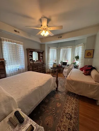 a living room with furniture a flat screen tv and a wooden floor