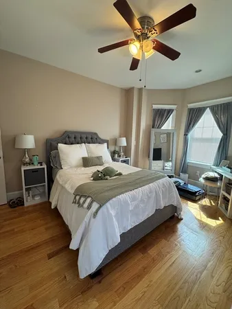 a bedroom with bed and a chandelier