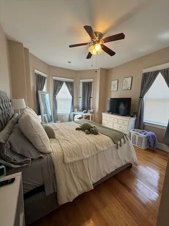 a bedroom with a large bed and a chandelier