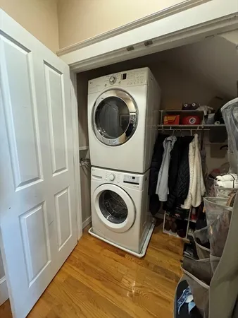 a kitchen with stainless steel appliances granite countertop wooden cabinets a stove a sink and a wooden floors