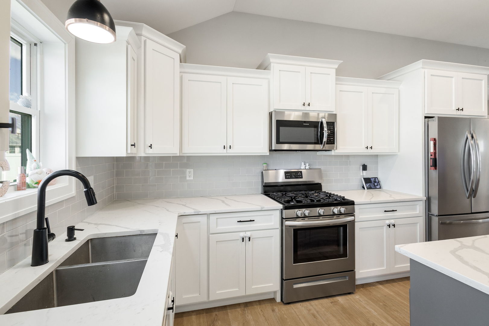 1059 Hummingbird Lane Peotone, IL 60468 - Photo 6 of 30 a kitchen with white cabinets and stainless steel appliances