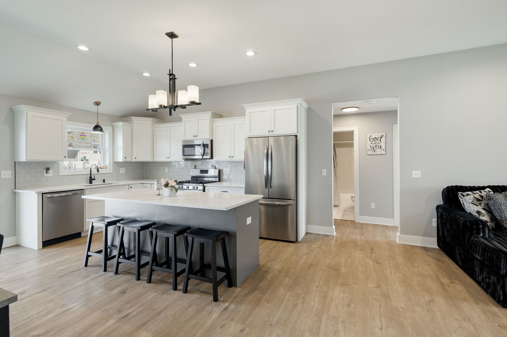 1059 Hummingbird Lane Peotone, IL 60468 - Photo 7 of 30 a kitchen with stainless steel appliances granite countertop a sink a stove a refrigerator and island with wooden floor