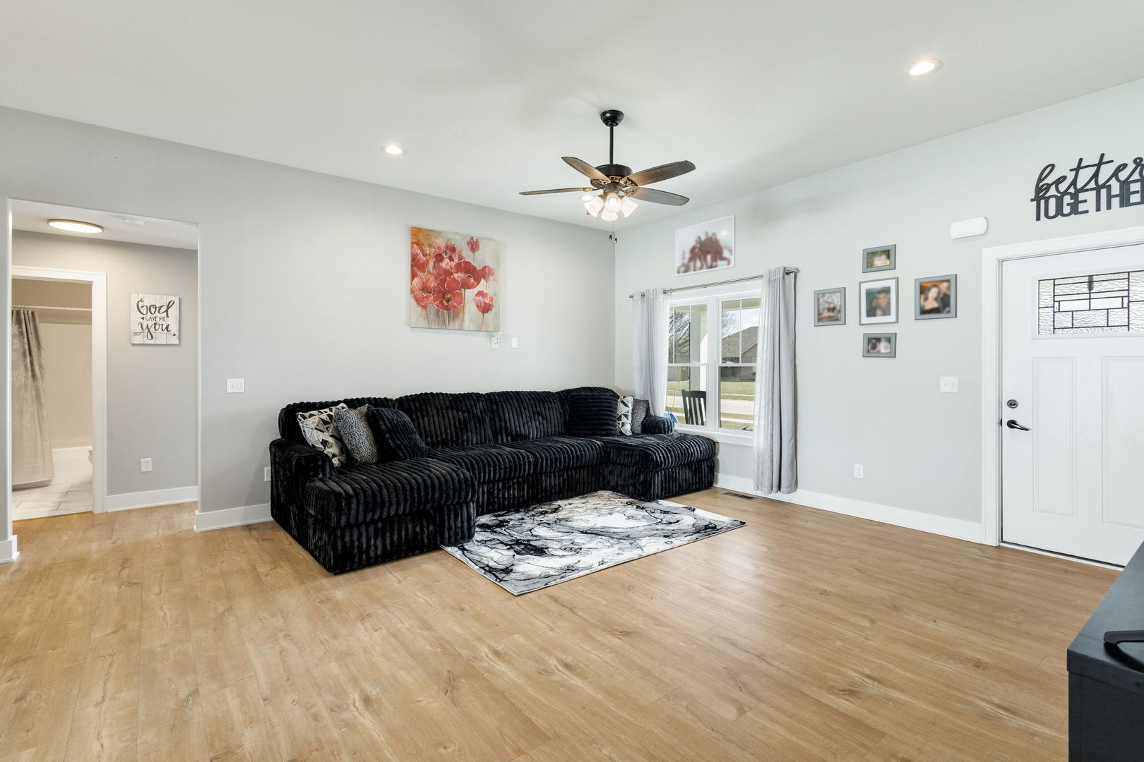 1059 Hummingbird Lane Peotone, IL 60468 - Photo 8 of 30 a living room with furniture a ceiling fan and a rug