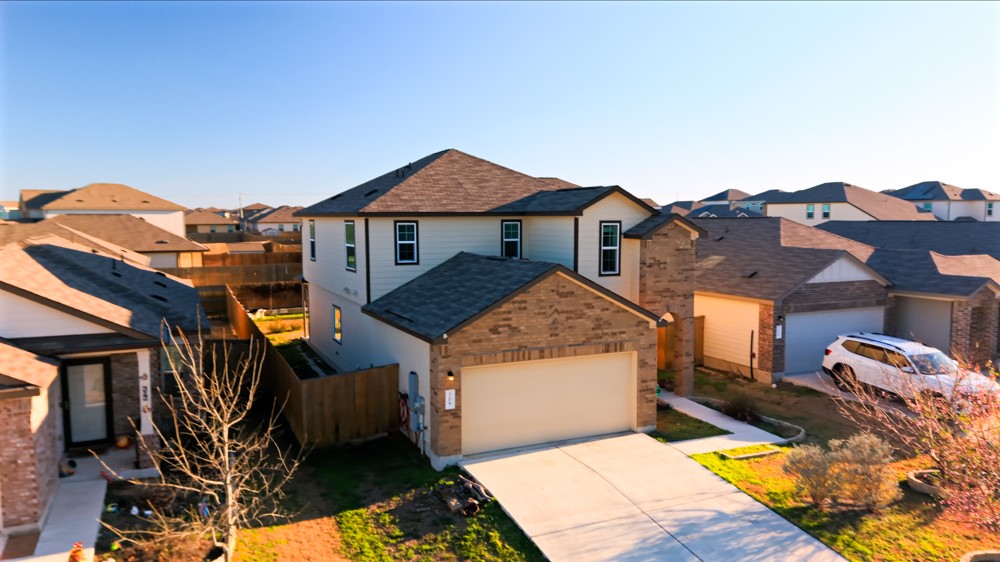 208 Greatest Gift Way Jarrell, TX 76537 - Photo 2 of 16 a view of a house with roof deck