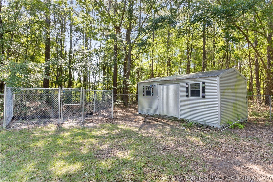 6568 Sandy Creek Road Stedman, NC 28391 - Photo 29 of 34 a view of a small yard and large trees