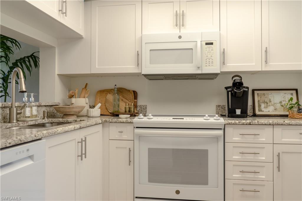 265 Deerwood Circle, Unit 10 Naples, FL 34113 - Photo 19 of 38 Kitchen featuring a sink, white cabinetry, and white appliances