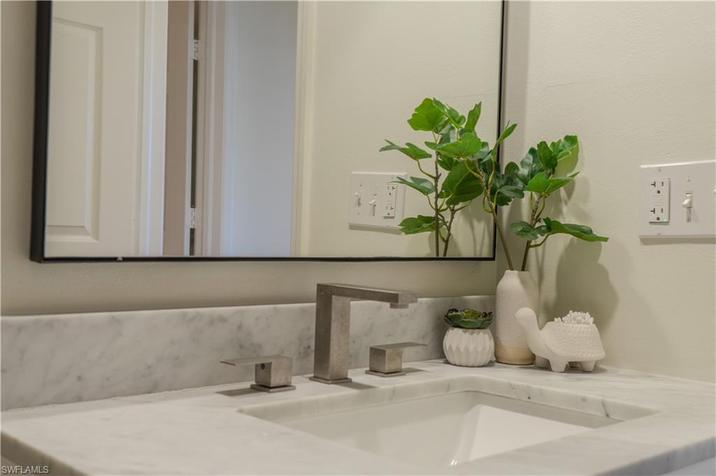 265 Deerwood Circle, Unit 10 Naples, FL 34113 - Photo 25 of 38 Room details with vanity