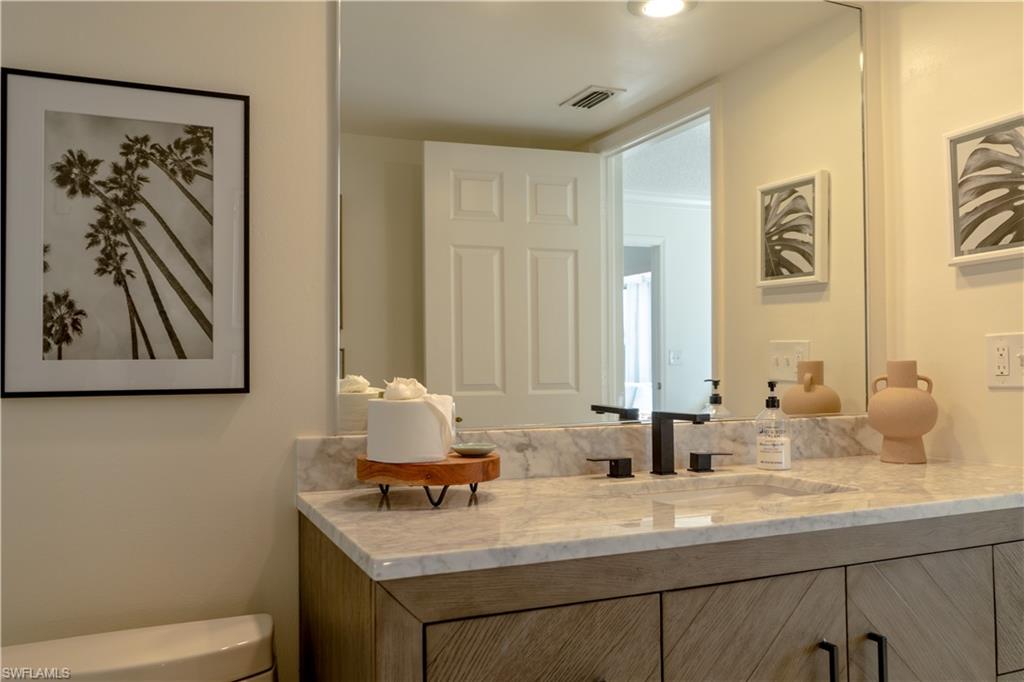 265 Deerwood Circle, Unit 10 Naples, FL 34113 - Photo 37 of 38 Bathroom with toilet, vanity, and visible vents