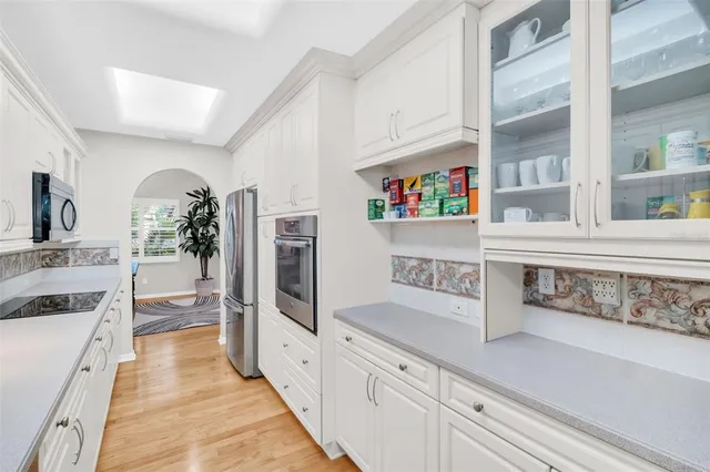a living room with a floor to ceiling windows and a table