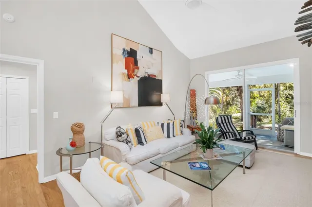 a living room with furniture fireplace and a large window