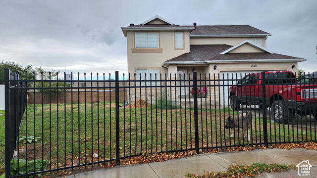 5948 Inheritance Court Taylorsville, UT 84123 - Photo 2 of 30 Two-story residence featuring a two-car garage, stucco exterior, and a dark shingle roof