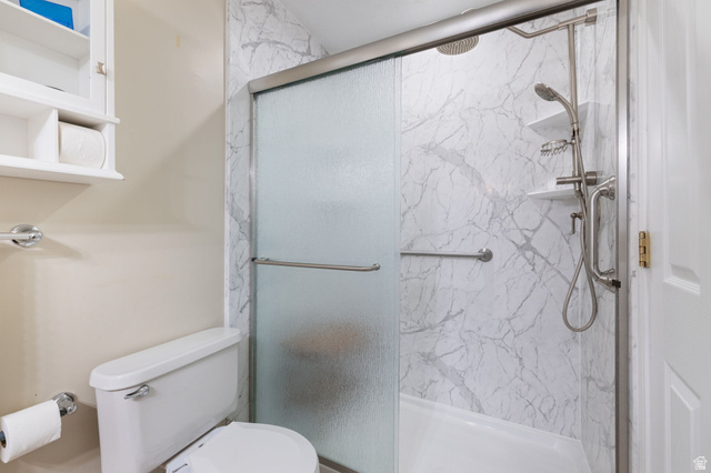 1625 Pages Pl Drive Bountiful, UT 84010 - Photo 17 of 31 Primary Bathroom with toilet and a marble finish shower
