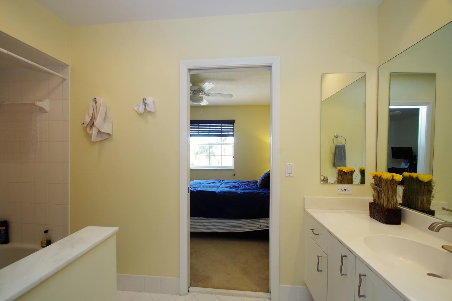 6535 Colomera Drive Boca Raton, FL 33433 - Photo 24 of 36 a en suite bathroom with a sink and a mirror