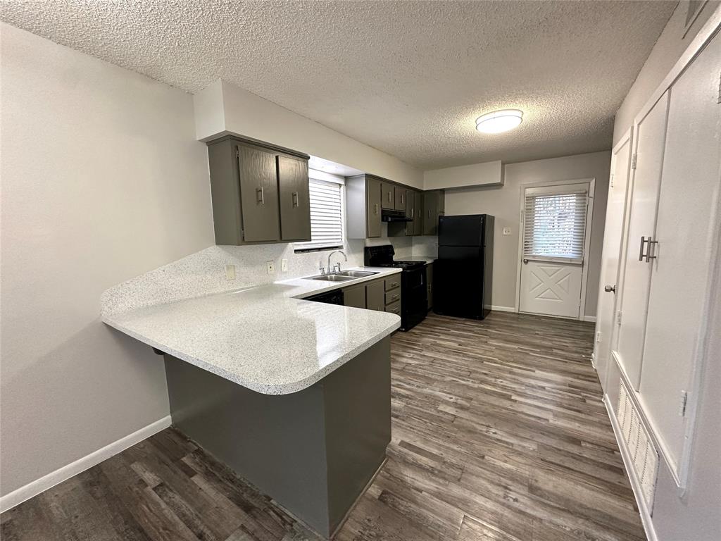 2006 Jane Street, Unit B Longview, TX 75601 - Photo 2 of 8 a kitchen with kitchen island a sink stove and refrigerator