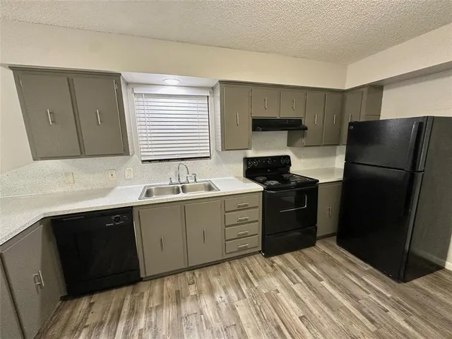 a kitchen with a refrigerator stove and sink