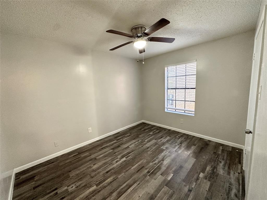 2006 Jane Street, Unit B Longview, TX 75601 - Photo 5 of 8 wooden floor in an empty room with a window