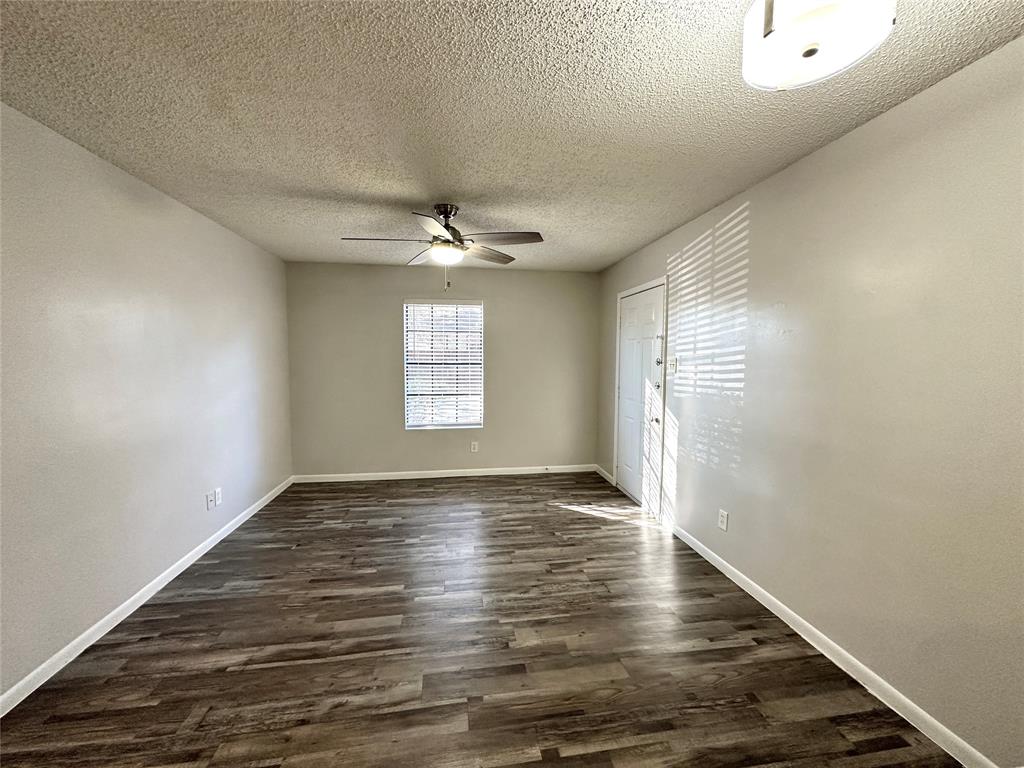 2006 Jane Street, Unit B Longview, TX 75601 - Photo 6 of 8 a view of an empty room with wooden floor and a window