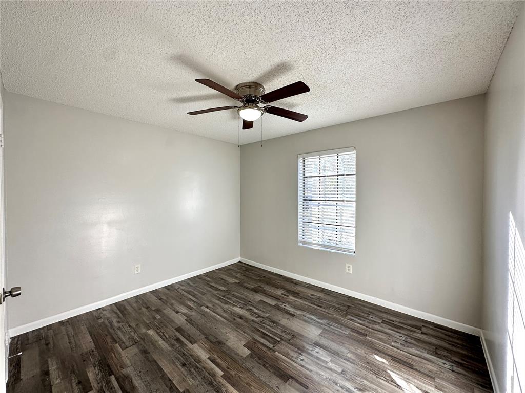2006 Jane Street, Unit B Longview, TX 75601 - Photo 7 of 8 a view of empty room with wooden floor and fan