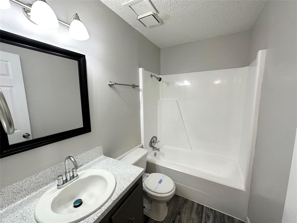 2006 Jane Street, Unit B Longview, TX 75601 - Photo 8 of 8 a bathroom with a sink a toilet and shower a mirror