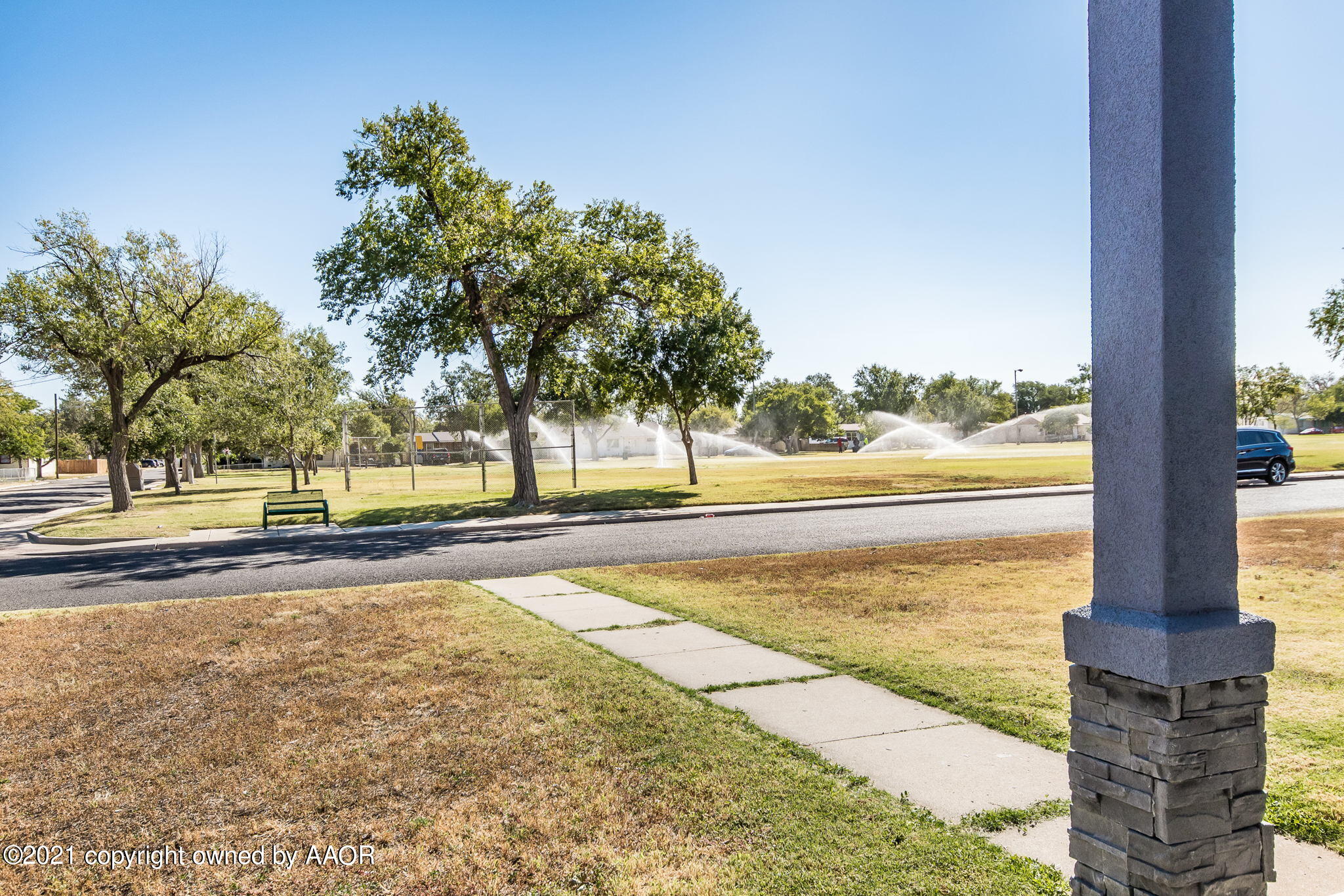 4400 Parker Street Amarillo, TX 79110 - Photo 23 of 24 a view of a swimming pool with a bench and trees around