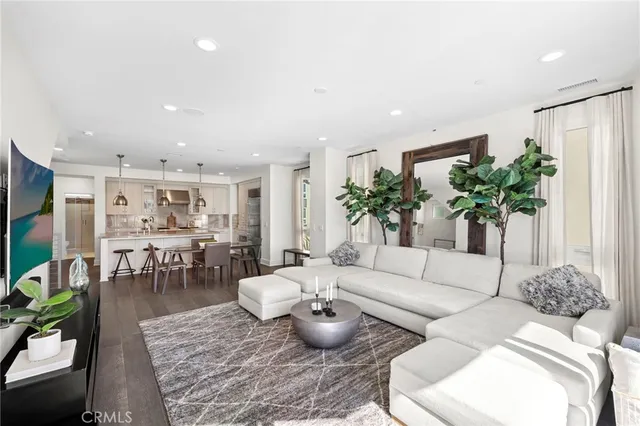 a living room with furniture potted plant and a large mirror