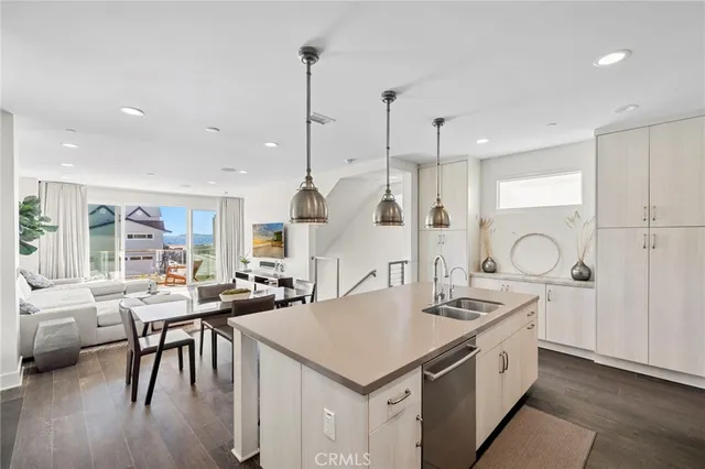 a kitchen with a table chairs stove and wooden floor