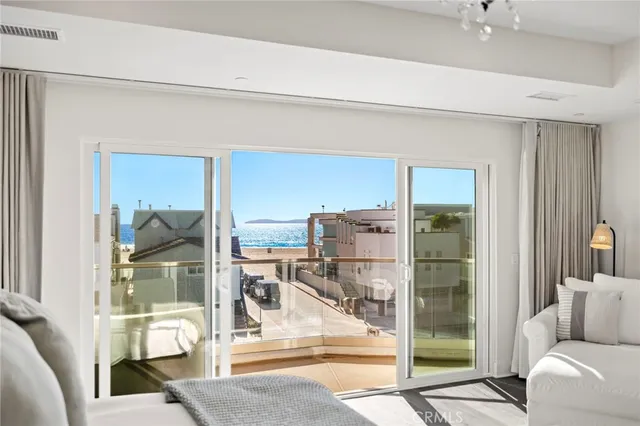 a living room with a floor to ceiling window and stairs