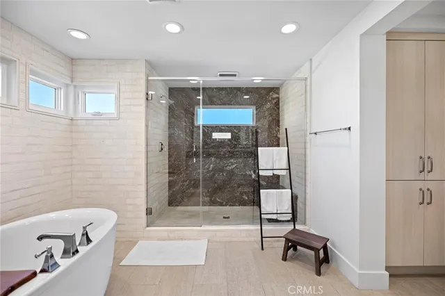 a bathroom with a bathtub and a shower