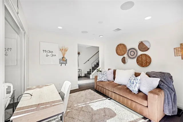 a living room with furniture and wall painting